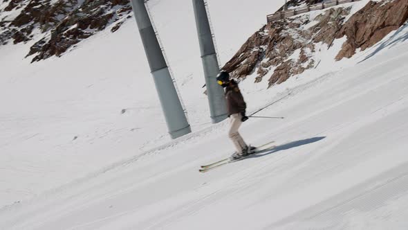 Woman Skiing Downhill Slope alt
