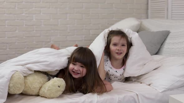 Two Cute Little Children Girls Cover with Blanket