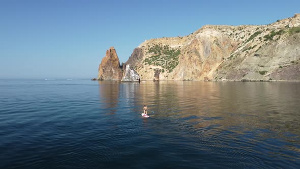 Aerial View From Above on Calm Azure Sea and Volcanic Rocky Shores alt
