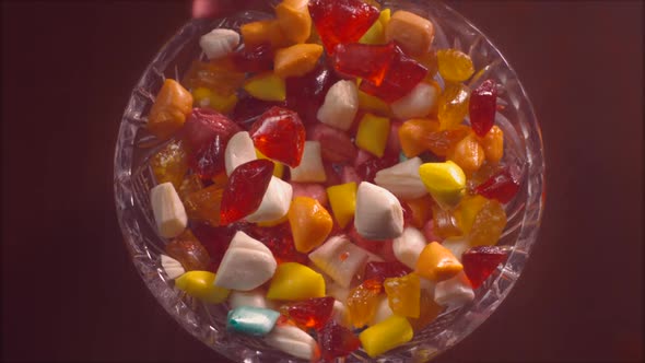 Rock candies falls down into a crystal plate in slow motion