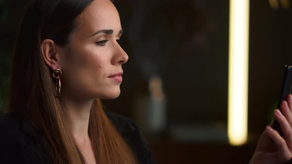 Serious Businesswoman Talking on Video Chat on Mobile Phone at Home Office alt