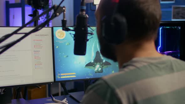 Back Shot of Streamer Man Playing on Powerful Computer alt