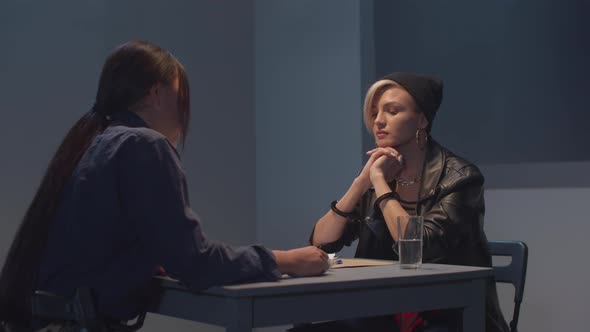 Police Officer Interrogates a Suspect. Arrest and Law alt