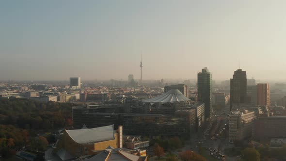 AERIAL: View of Berlin, Germany Alexanderplatz TV Tower with Beautiful Orange Autumn Sunlight Haze  alt