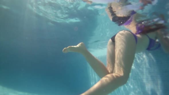 Underwater view of woman in swimming pool