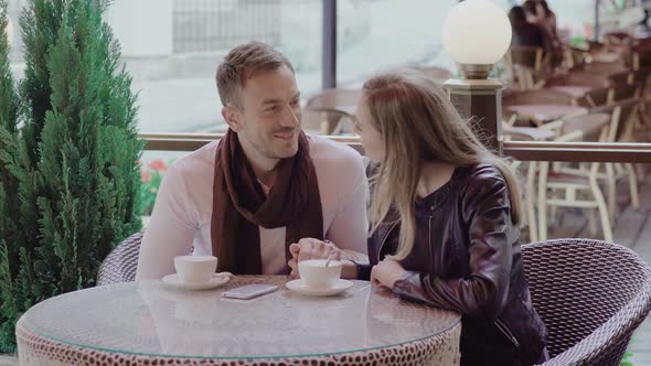 Romantic Couple Drinking Coffee On Date At Street Cafe alt