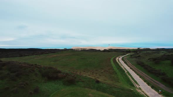 Drone Over Landscape To Rubjerg Knude Lighthouse alt