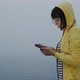 Sleepy Woman Uses Smartphone for Navigation in Foggy Morning By the Water - VideoHive Item for Sale