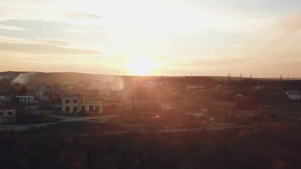 view of the suburban infrastructure which covered with smoke after a fire from a drought at sunset alt