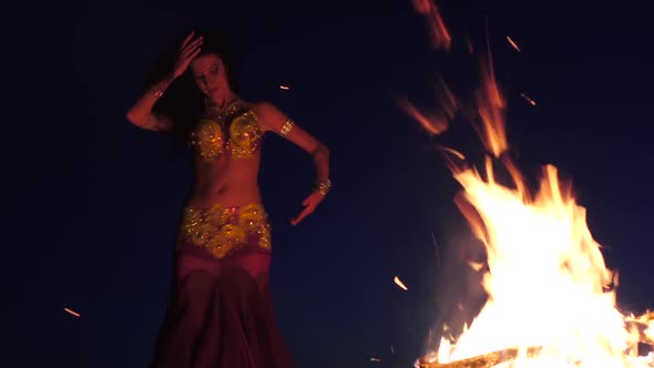 Late Night a Girl in the Sand Dancing Belly Dancing Near a Bright Campfire alt