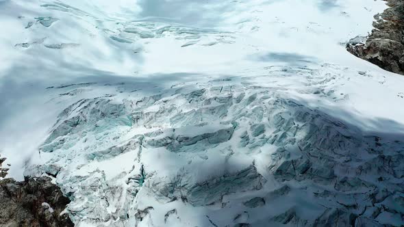 Flying towards a glacier in the Andes of Peru to view a glacier that is melting and shrinking doe to alt