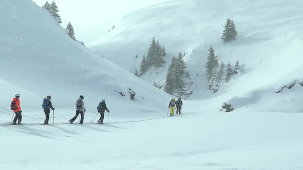 Group of children doing ski touring with a guide instructor. Ski touring in the mountains alt