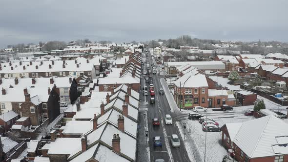 Aerial view heavy traffic on Anchor road Longton, a sudden snow blizzard in Stoke on Trent, dangerou alt
