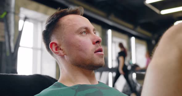 A Young Pumped Up Athlete Does Another Leg Exercise In The Gym In Preparation For Competition. alt