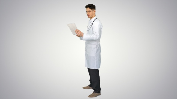 Attractive confident doctor dancing with tablet after reading alt