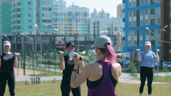 Group of women doing fitness exercises outdoors