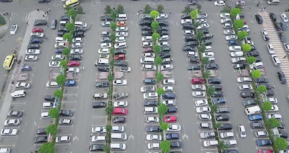 Top Aerial Crane style shot with drone over the shopping mall's Huge parking lot alt