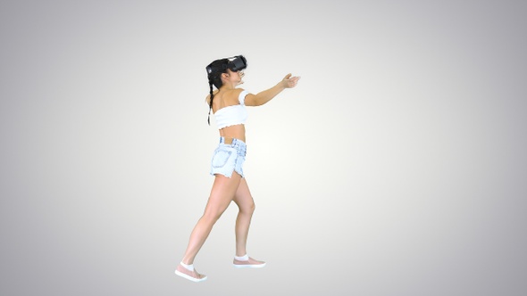 Woman using VR Virtual Reality headset walking and dancing alt