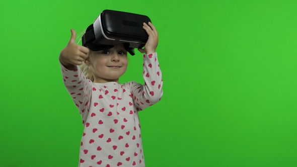 Child Girl Using VR Headset Helmet To Play Game. Watching Virtual Reality 3d 360 Video. Chroma Key alt