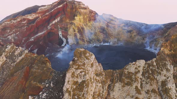 Aerial View of Volcano Crater Spewing White Gas and Ashes alt