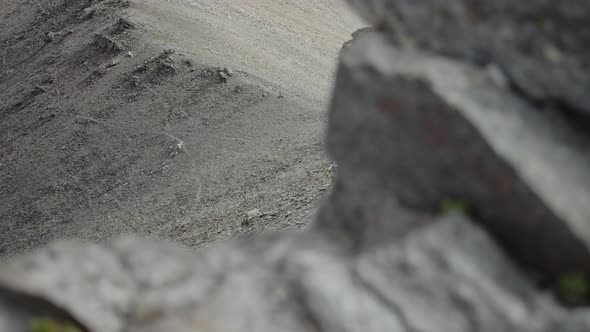 Panorama of a Man Climbing on a Rocky Pass in a Big Mountains