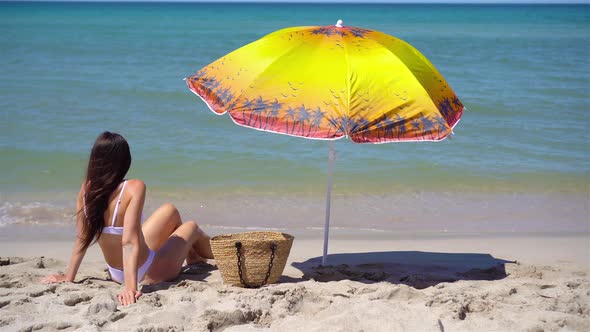 Young Woman in Hat on the Beach Vacation