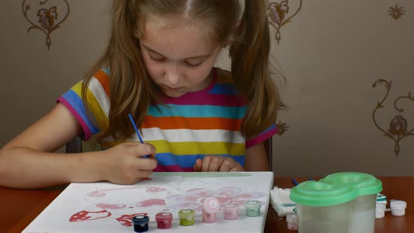 Closeup of a Girl Drawing with Colored Paints on Paper