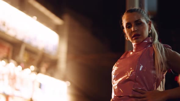 Woman In Pink Pvc Clubwear Spinning And Dancing To Camera By Neon alt