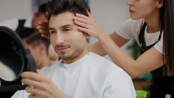 Handheld view of man having visit to the hairdresser. Shot with RED helium camera in 8K alt