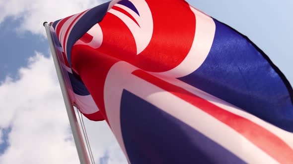 UK British flag hanging on flagstaff alt