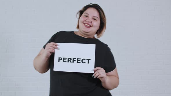 Concept Body Positivity an Overweight Smiling Woman Dancing and Holds a Sign with the Inscription alt