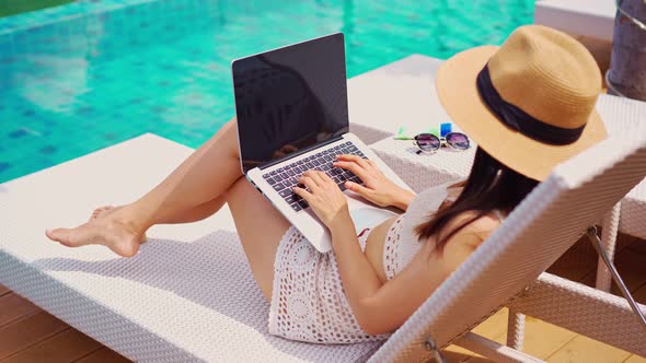 Young woman freelancer traveler working online using laptop while traveling on summer