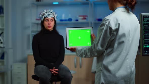 Doctor Holding Tablet with Green Screen in Neurological Research Lab alt