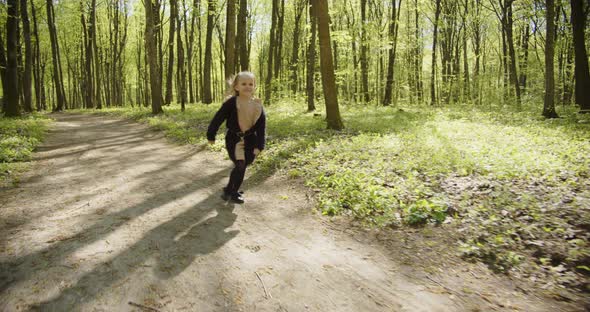 Little Happy Girl Runs On A Forest Path alt