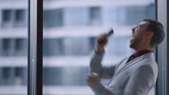 Euphoric Business Man Celebrating Career Success in Corporate Office Building alt