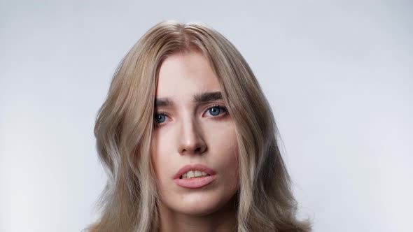 Confusion Attractive Girl Look at Camera Blonde Face Closeup White Background  alt