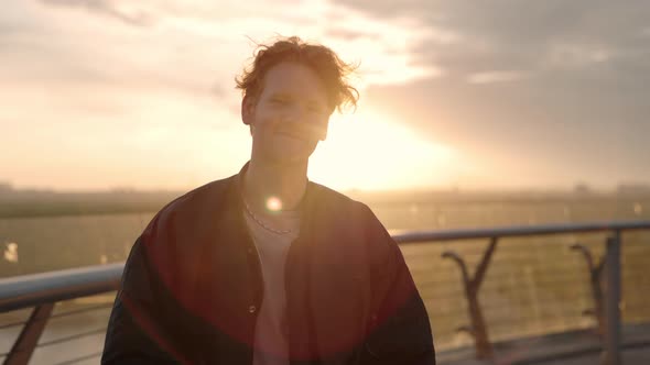 Portrait of Man with Red Hair Enjoying Sunset Outdoors alt