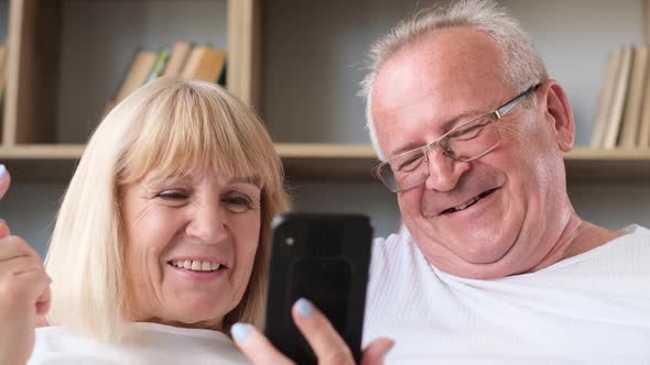 Happy Family of Senior Couple Having Fun Taking Selfie Photo Together on Smartphone alt