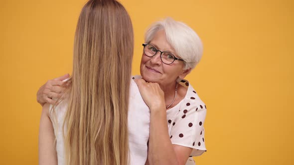 Senior Woman Hugging Her Daughter. Family Bonding Concept alt