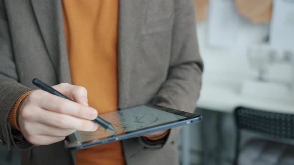 Closeup of Male Hands Drawing Clothes Picture with Graphic Tablet Working Indoors alt