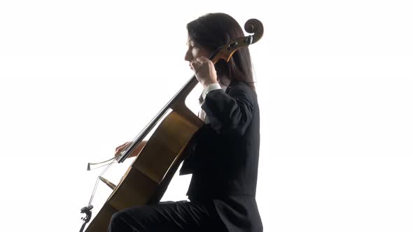 Female Hand Plays with a Bow on a Cello in White Studio . White Background. Side View alt