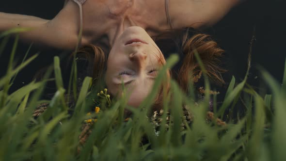 Young Sensual Beauty Woman with Wreath of Flowers Floats on Her Back on the Lake alt