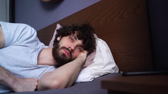 Closeup Face of Sleeping Young Man Opening Eyes Waking Up and Happy Looking Away alt