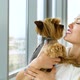 Beautiful Blonde Woman Holding Small Yorkshire Terrier Dog Kissing her - VideoHive Item for Sale