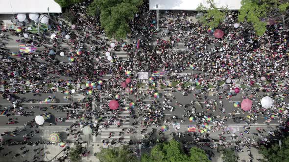 aerial drone shot of a diverse crowd walking during mexico city's pride parade on paseo de la reform alt