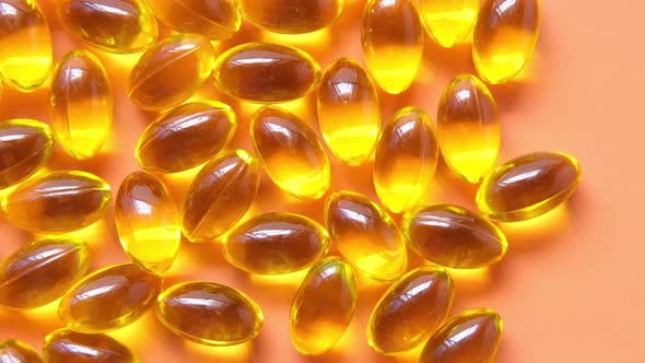 Fish Oil Supplement on Orange Background alt