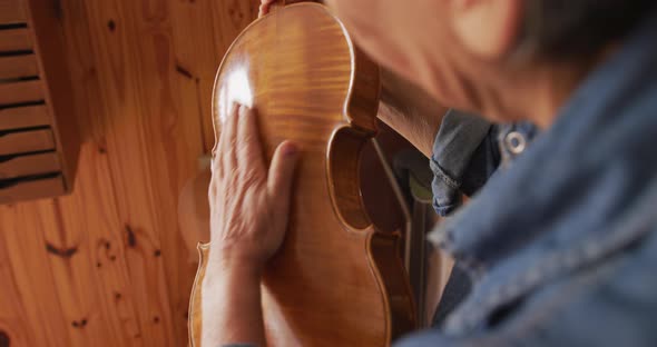 Female luthier at work in her workshop alt