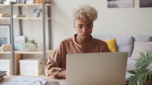 Businesswoman at Home Raising Arms in Celebration of Successful Job Promotion alt