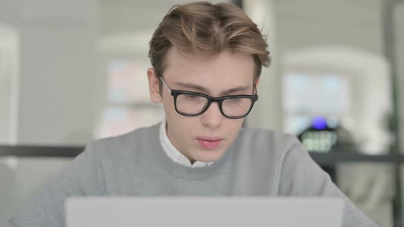 Close Up of Young Man Working on Laptop alt