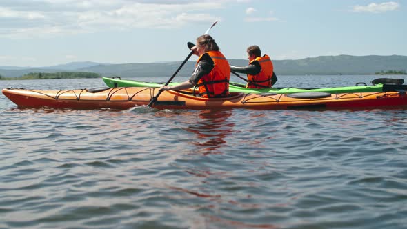 Couple Paddling in Lake alt